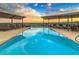 Rooftop pool area with lounge chairs and stunning city views at sunset at 7175 E Camelback Rd # 401, Scottsdale, AZ 85251