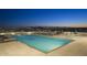 Relaxing rooftop pool area with lounge chairs and stunning city and mountain views at twilight at 7175 E Camelback Rd # 401, Scottsdale, AZ 85251