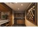 Stylish wet bar featuring custom cabinets, wine fridge, granite counters, and decorative painting at 7175 E Camelback Rd # 401, Scottsdale, AZ 85251