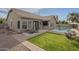 Backyard features a pool, patio, artificial grass, and fire pit area at 7252 E Nido Ave, Mesa, AZ 85209