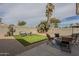 Backyard with an artificial turf area, a patio, and an outdoor fire pit at 7252 E Nido Ave, Mesa, AZ 85209