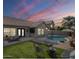 Beautiful backyard featuring a pool, manicured lawn, and outdoor seating area perfect for entertaining at 7252 E Nido Ave, Mesa, AZ 85209