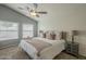 Beautiful bedroom featuring a vaulted ceiling, white shiplap wall, plush carpet, and a ceiling fan at 7252 E Nido Ave, Mesa, AZ 85209