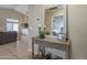Entryway featuring wood-look console table, decorative mirror, tiled floor, and access to the living room at 7252 E Nido Ave, Mesa, AZ 85209