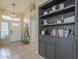 Inviting foyer with tiled flooring, a beautiful light fixture, and a built-in bookcase at 7252 E Nido Ave, Mesa, AZ 85209
