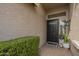 A welcoming front entryway featuring a black door, beautiful plants, and a 'hello' doormat at 7252 E Nido Ave, Mesa, AZ 85209
