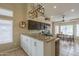 Modern eat-in kitchen featuring granite countertops, stainless steel appliances, and stylish light fixture at 7252 E Nido Ave, Mesa, AZ 85209
