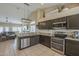 Open kitchen featuring granite countertops, stainless steel appliances, and a view into the living area at 7252 E Nido Ave, Mesa, AZ 85209
