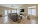 Bright living room with a comfortable sectional sofa, a fireplace, and a ceiling fan at 7252 E Nido Ave, Mesa, AZ 85209