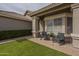 Quaint front patio with chairs, perfect for relaxing and enjoying the beautiful neighborhood views at 7252 E Nido Ave, Mesa, AZ 85209