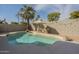 Backyard with a sparkling pool, patio, and lush tropical landscaping at 7252 E Nido Ave, Mesa, AZ 85209