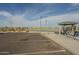 Outdoor community tennis courts with shaded picnic tables and parking spaces at 7252 E Nido Ave, Mesa, AZ 85209