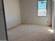 An unfinished bedroom with a window showcasing the exterior and drywall installed at 9613 W Parkway Dr, Tolleson, AZ 85353