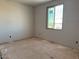 Unfinished bedroom featuring a window providing natural light and outdoor views at 9613 W Parkway Dr, Tolleson, AZ 85353