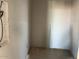 A storage closet with plywood floors and walls ready for paint and shelving at 9613 W Parkway Dr, Tolleson, AZ 85353
