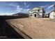 Exterior of two-story home under construction, with spacious lot and visible neighborhood homes nearby at 9613 W Parkway Dr, Tolleson, AZ 85353