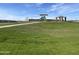 A community playground with green grass, walking trail, gazebo and lots of playground equipment at 9613 W Parkway Dr, Tolleson, AZ 85353