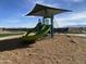 Community playground features a fun slide and climbing area with protective shade in a Gathering friendly environment at 9613 W Parkway Dr, Tolleson, AZ 85353