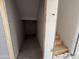 Unfinished stairway, located next to a storage area, leading to an upper level in a home construction site at 9613 W Parkway Dr, Tolleson, AZ 85353