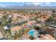 Beautiful aerial view highlighting the neighborhood with community pool, mature trees, and mountain views at 9705 E Mountain View Rd # 1143, Scottsdale, AZ 85258
