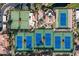 Birds-eye view of tennis courts and community clubhouse surrounded by lush landscaping and mature trees at 9705 E Mountain View Rd # 1143, Scottsdale, AZ 85258