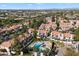 Scenic aerial view showcasing the community, lush landscaping, mature trees, and a sparkling pool at 9705 E Mountain View Rd # 1143, Scottsdale, AZ 85258