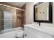 Bathroom featuring white vanity, framed mirror, and tiled shower-tub combination, providing a clean design at 9705 E Mountain View Rd # 1143, Scottsdale, AZ 85258