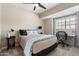 Comfortable bedroom setup with a desk, chair, and ceiling fan, perfect for work or relaxation at 9705 E Mountain View Rd # 1143, Scottsdale, AZ 85258