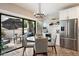 Chic dining area with stainless steel refrigerator, tile backsplash, and an outdoor patio at 9705 E Mountain View Rd # 1143, Scottsdale, AZ 85258