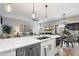Bright, open kitchen island with breakfast bar, modern appliances, and a view to the living room at 9705 E Mountain View Rd # 1143, Scottsdale, AZ 85258