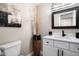 Stylish powder room boasts a modern vanity, black faucet, decorative vase and artwork enhancing its appeal at 9705 E Mountain View Rd # 1143, Scottsdale, AZ 85258