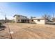 Backyard featuring a two story home with a covered patio and dirt at 1153 E 12Th St, Casa Grande, AZ 85122