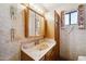 Compact bathroom featuring a vanity, wood accents, and basic fixtures at 1153 E 12Th St, Casa Grande, AZ 85122