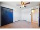 This bedroom features a ceiling fan, a closet, and access to an adjacent bathroom at 1153 E 12Th St, Casa Grande, AZ 85122