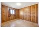 This bedroom features a ceiling fan, a window with curtains, and wood paneled walls at 1153 E 12Th St, Casa Grande, AZ 85122