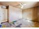 This bedroom features a ceiling fan and door with a doorway to an adjacent bathroom at 1153 E 12Th St, Casa Grande, AZ 85122