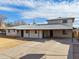 Two-story home featuring white-painted brick, a wide carport, and a spacious concrete driveway at 1153 E 12Th St, Casa Grande, AZ 85122