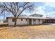 Traditional home with covered parking and a mature shade tree in the front yard at 1153 E 12Th St, Casa Grande, AZ 85122