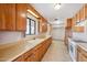 Extended kitchen features wooden cabinets, laminate countertops, and lots of natural light at 1153 E 12Th St, Casa Grande, AZ 85122