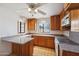 Upgraded kitchen featuring granite countertops, wooden cabinetry, and vinyl flooring at 1153 E 12Th St, Casa Grande, AZ 85122