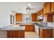 Modern kitchen with wood cabinets, granite countertops, and a center island at 1153 E 12Th St, Casa Grande, AZ 85122