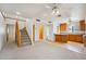 Open-concept living room and kitchen featuring a staircase, ceiling fans and bright lighting at 1153 E 12Th St, Casa Grande, AZ 85122