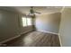 Bright bedroom with wood-look floors and abundant natural light at 1167 W Dana Dr, San Tan Valley, AZ 85143