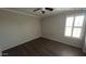 Comfortable bedroom featuring wood-look floors, a ceiling fan, and natural light at 1167 W Dana Dr, San Tan Valley, AZ 85143