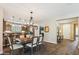 Open concept dining area leading to kitchen with wooden cabinets and stainless steel appliances at 12734 W Crestvale Dr, Peoria, AZ 85383