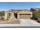 Charming tan home featuring a two-car garage, stone accents, and a well-maintained desert landscape at 12734 W Crestvale Dr, Peoria, AZ 85383