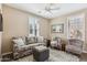 Cozy living room with a ceiling fan, plantation shutters, and comfortable seating arrangements at 12734 W Crestvale Dr, Peoria, AZ 85383