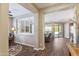 Open-concept living room showcasing wood-look floors, plantation shutters, and a seamless flow to the outdoor patio at 12734 W Crestvale Dr, Peoria, AZ 85383