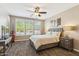 Spacious bedroom featuring plantation shutters, a ceiling fan, and wood-look flooring throughout at 12734 W Crestvale Dr, Peoria, AZ 85383