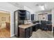 Home office space with built-in cabinets, desk area, and view into an adjacent dining room at 12734 W Crestvale Dr, Peoria, AZ 85383